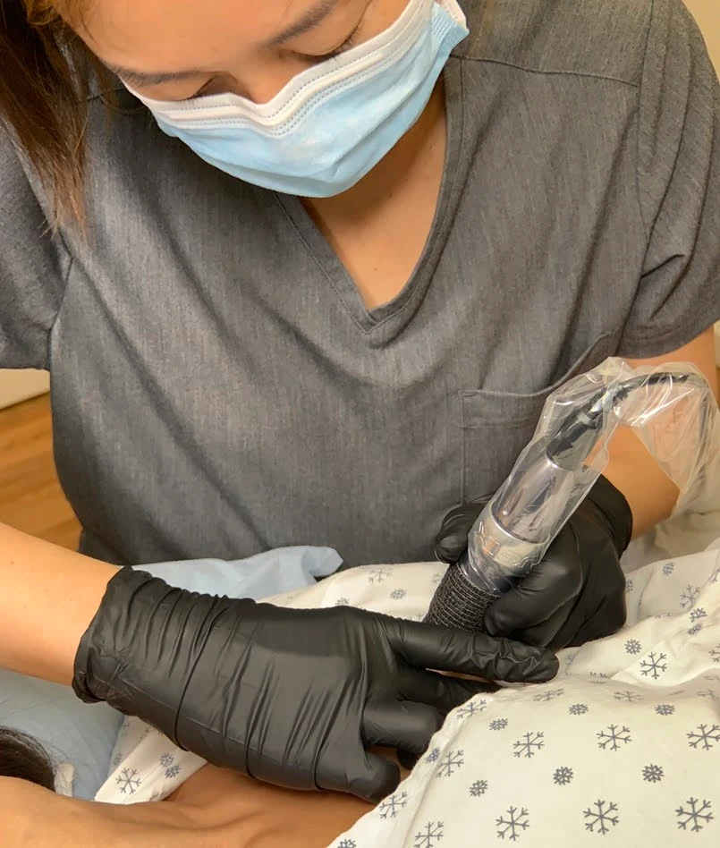 Medical tattoo artist at work